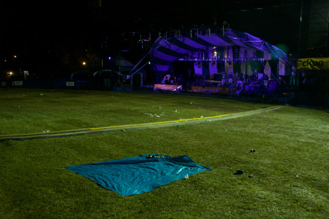 A lone tarp in front of the main stage at Folk Fest